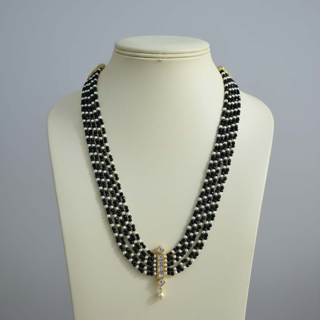 Black pearl necklace on ivory mannequin bust