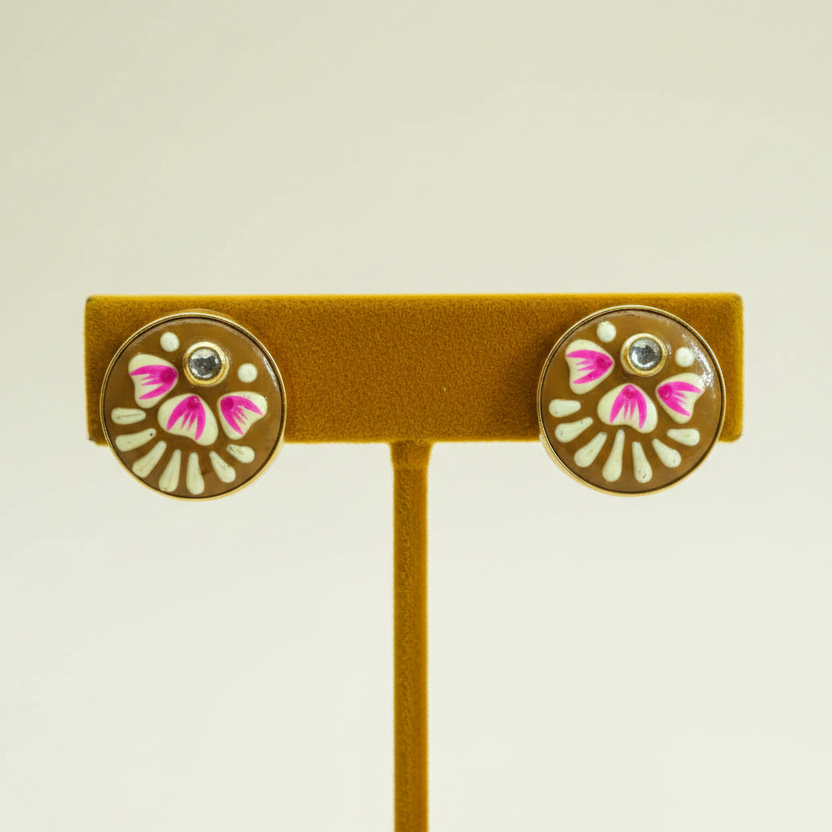 Golden brown meenakari studs on mustard gold velvet stand
