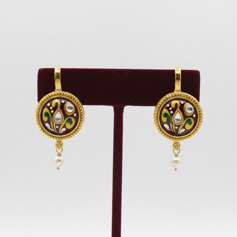 Maroon earrings on burgundy velvet stand