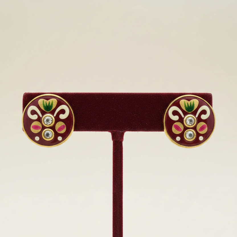 Maroon meenakari studs on wine red velvet stand