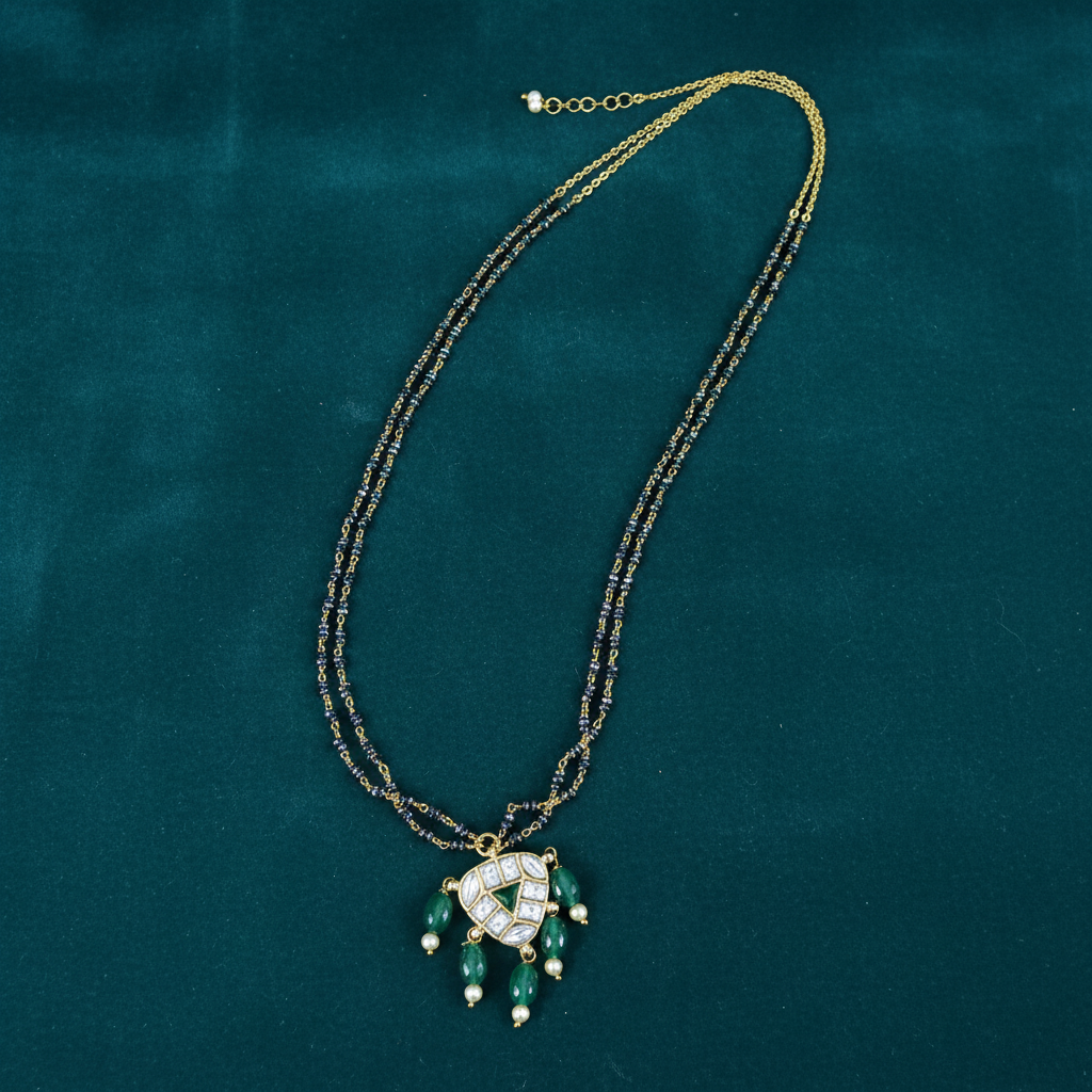 Necklace on deep teal velvet background
