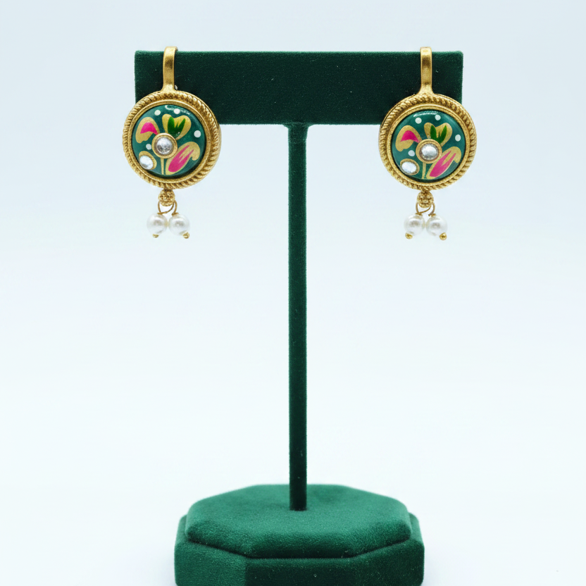 Teal earrings on emerald velvet stand