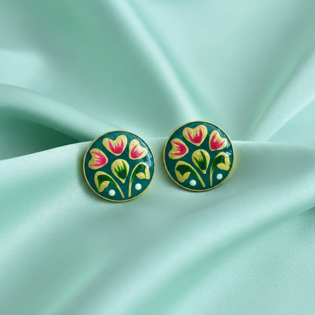Teal stud earrings on mint silk with pastel background